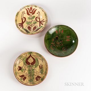Three Breininger Slip-decorated Redware Plates, Robesonia, Pennsylvania, 1985, sgraffito-decorated with tulips and birds, coggled rims,