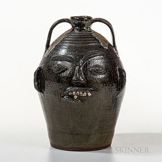 Two Pottery Face Jugs, 20th century, the smaller by Chester Hewell, the larger stamped "CL" probably for Charles Lisk, ht. 10 1/2, 15 1