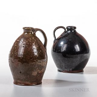 Two Glazed Redware Jugs, a black-glazed example, Pennsylvania, c. 1820-40, and one greenish red, probably New England, 19th century, ea