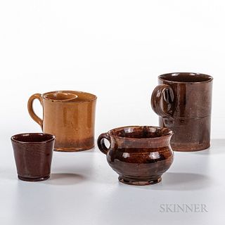 Four Pieces of Glazed Redware, probably New England, 19th century, a porringer with mottled tan and red glaze with splotches, a beaker,