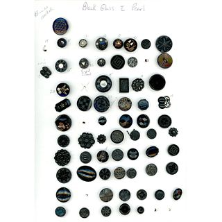 A CARD OF ASSORTED BLACK GLASS BUTTONS.