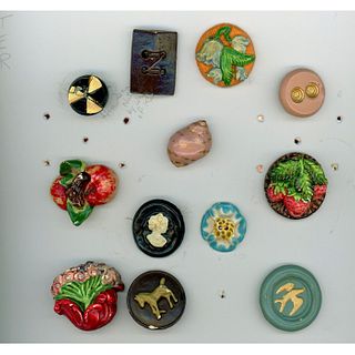 A CARD OF ASSORTED PLASTER BUTTONS