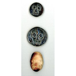 A SMALL CARD OF SKULL BUTTONS