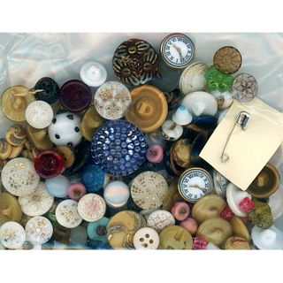 A BAG LOT OF ASSORTED COLORED GLASS BUTTONS