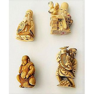A SMALL CARD OF CARVED NETSUKE FIGURES.