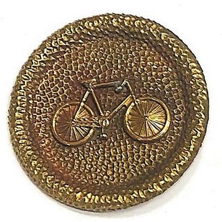 A DIVISION THREE BRASS BICYCLE BUTTON