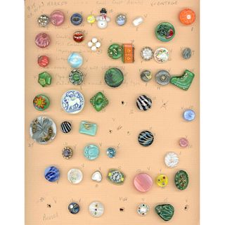 A WHOLE CARD OF DIVISION 3 ASSORTED MOONGLOW BUTTONS
