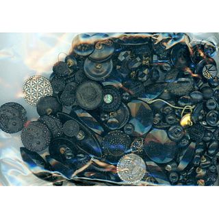 A HEAVY BAG LOT OF ASSORTED BLACK GLASS BUTTONS