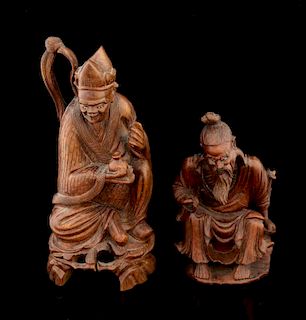 Two Chinese carved hardwood figures of seated robed men on integral naturalistic bases, 23cm high an
