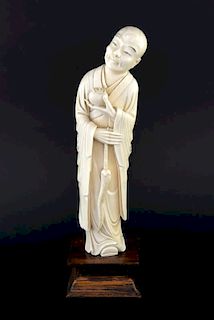 Late 19th/early 20th century Chinese carved ivory figure of a bald man holding a small pot in his le
