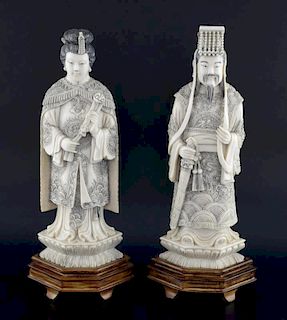 Pair of early 20th century Chinese carved ivory Emporer and Empress figures, he holding a sword, she