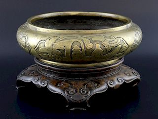 Chinese bronze censer decorated with four panels figures and dragons, on carved hardwood stand, 25cm
