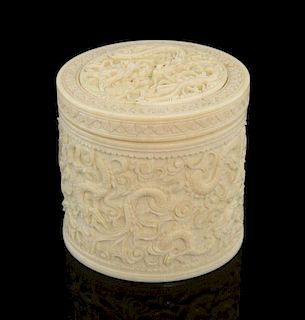 Early 20th century carved ivory cylindrical box and cover carved with dragons amongst clouds, 9cm hi