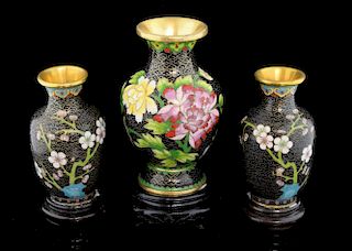 Pair of modern Chinese cloisonne vases, the black ground decorated with flowers and foliage, on hard