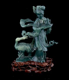 Chinese moulded glass figure of a lady with a tray and teapot and a crane at her feet, on hardwood b