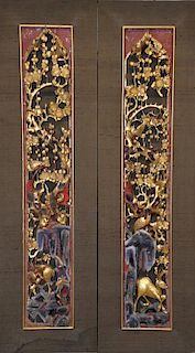 Pair of Chinese relief carvings of birds and deer in a landscape setting, decorated in red and gilt,