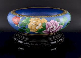 20th century Chinese cloisonne bowl, the blue ground decorated with flowers and foliage, on hardwood