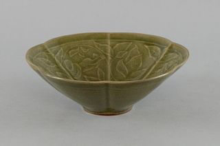 Chinese Longquan style celadon six-lobed bowl with moulded figural and foliate decoration on unglaze