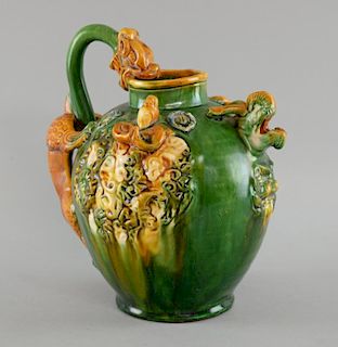 Chinese green and yellow glazed jug with applied dragon handle, figural and mask decoration, impress