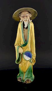 Chinese glazed pottery figure of a man in yellow, green and blue glazes, 41cm high,