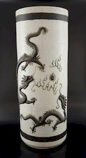 20th century Chinese crackle glazed stick stand with raised decoration of two dragons chasing the fl