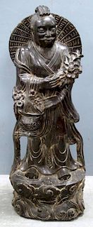 Chinese carved stone figure of a man with a basket of flowers on naturalistic base, 98cm high,