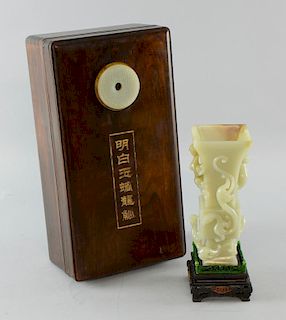 Chinese pale celadon jade vase of GU form with relief carving of five dragons, on carved hardwood st
