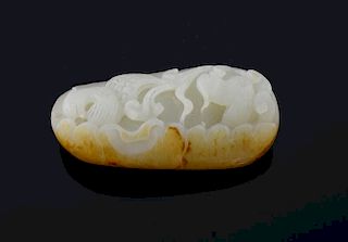 Chinese white and mottled brown jade pendant carved with two birds amongst foliage, 7cm long,