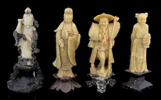 Four Chinese soapstone figures, three carved as women, the other as a man wearing a hat, on variousl