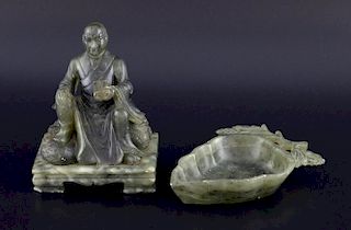 Chinese soapstone carving of a man sitting on a rock and holding a scroll, on shaped integral base,