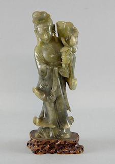Chinese soapstone carving of a lady holding a lily flower and pad, on naturalistic base, 29cm high,