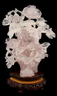 Chinese rose quartz vase and cover with carved floral decoration, on hardwood stand, 24cm high,