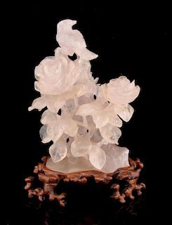 Chinese rose quartz carving of a bird amongst flowers and foliage, on hardwood base, 20cm high,