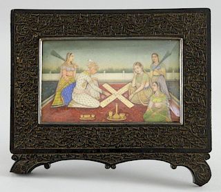 19th century Indian miniature painting on ivory depicting a group of figures, three seated on a carp