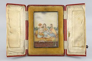 19th century Indian miniature painting on ivory depicting a man and two women seated on a golden car