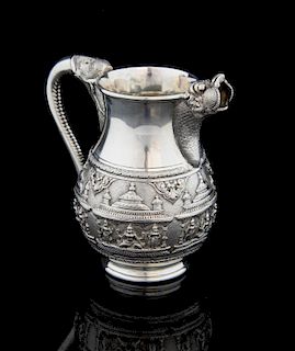 Indian silver jug with embossed figural and temple decoration with scrolling elephant's trunk handle