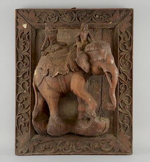 Indian carved hardwood panel with an elephant and riders carved in deep relief framed by scrolling f