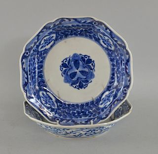 Pair of Japanese Arita octagonal blue and white dishes with scrolling floral decoration, six charact