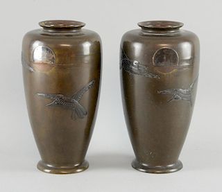 Pair of Japanese Meiji period bronze vases decorated with crows in front of a setting sun, 22cm high
