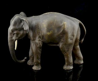 Japanese bronze model of a standing elephant, with ivory tusks, 11.5cm high, (one tusk missing),