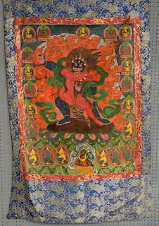 Tibetan Thangka painting depicting a figure with sharp pointed teeth being embraced by a red-skinned