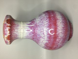 A CHINESE FLAMBE BOTTLE VASE, THE RED BODY WITH LAVENDER STREAKS, HEIGHT 32CM