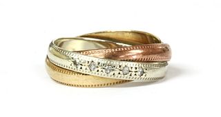 A 9ct three colour gold diamond set three band ring,