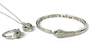 A silver chrome diopside and diamond set panther bangle, pendant and ring suite,