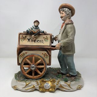 Capodimonte man statue pushing music box with Monkey