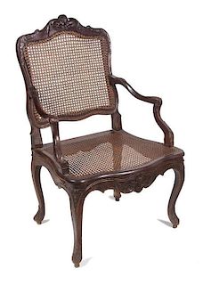 A Louis XV Style Carved Walnut Fauteuil Height 38 1/2 inches.