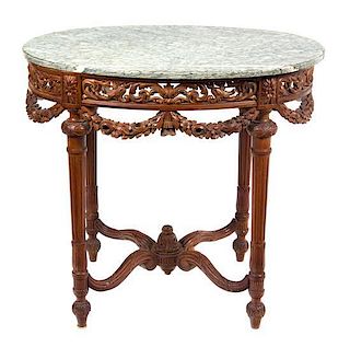 A Louis XVI Style Carved Fruitwood Marble Top Center Table Height 29 3/4 x width 33 1/4 x depth 25 inches.
