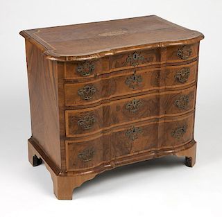 A Continental Baroque four-drawer walnut dresser