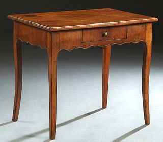 French Provincial Louis XV Style Carved Walnut Side Table, 19th c., the ogee edge rectangular top over a scalloped skirt with a central frieze drawer,