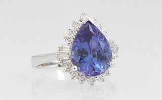 Lady's 14K White Gold Dinner Ring, with a 3.66 carat pear shaped tanzanite, atop a conforming border of round and baguette diamonds, total diamond wt.